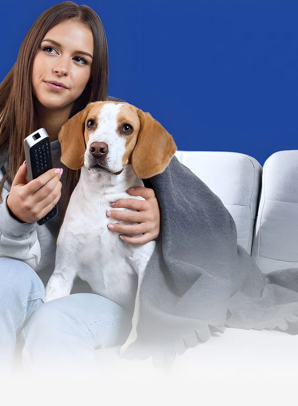 Woman sitting on a couch with her emotional support dog, representing housing accommodations with an ESA letter online